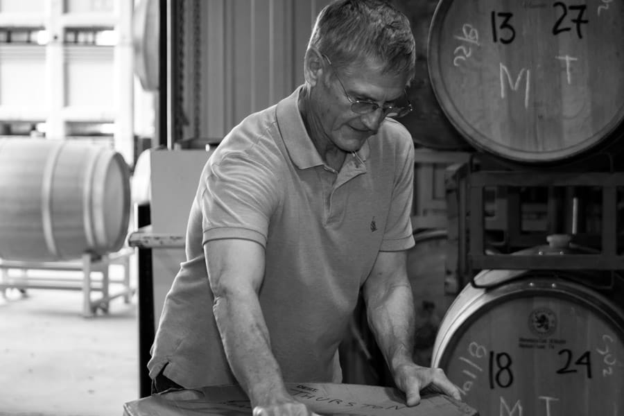 Man handling a box in a winery.
