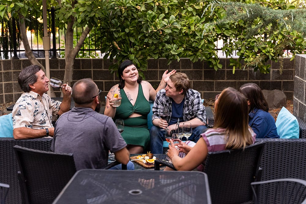 Group enjoying drinks and conversation outdoors