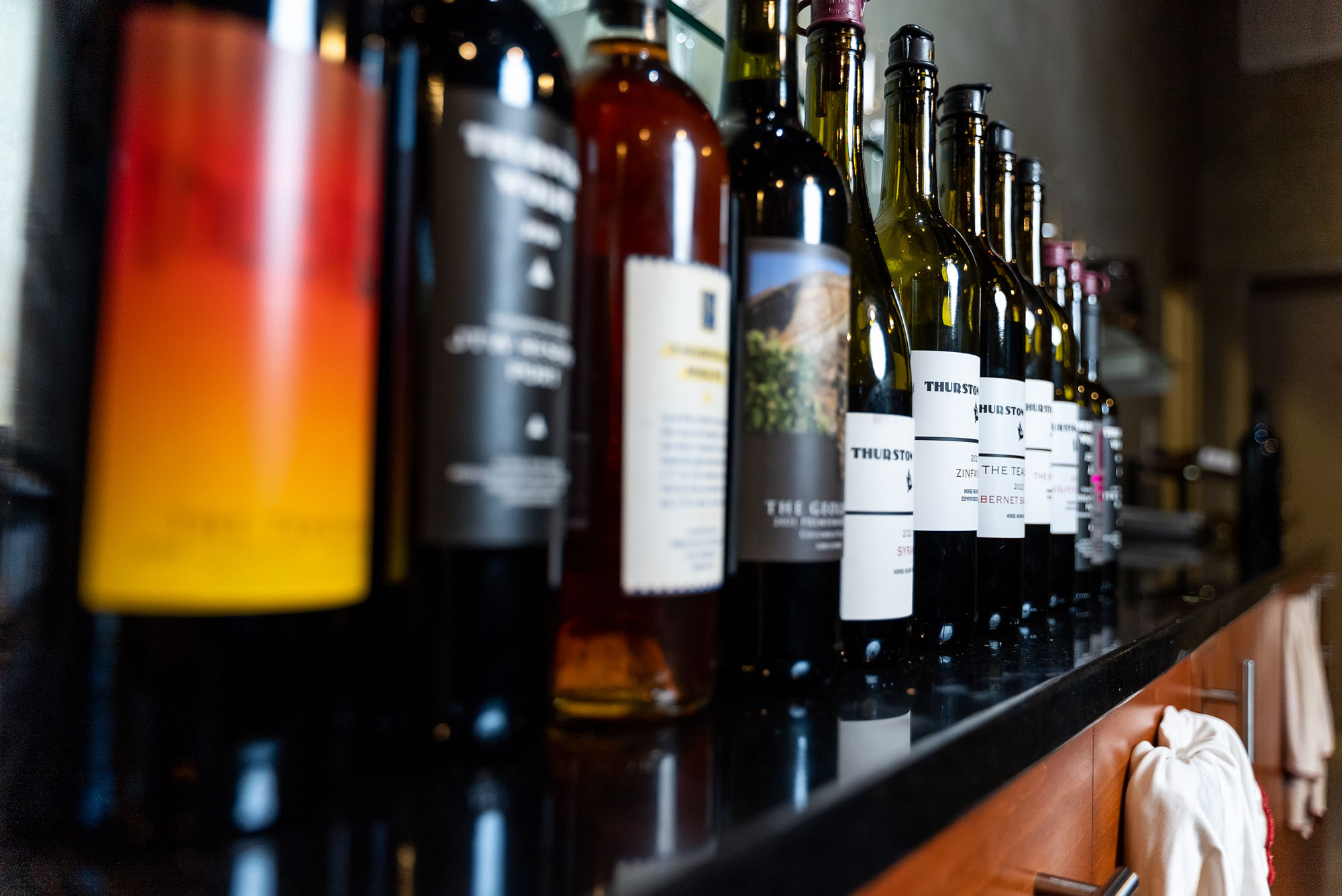 Bottles of wine lined up on a counter