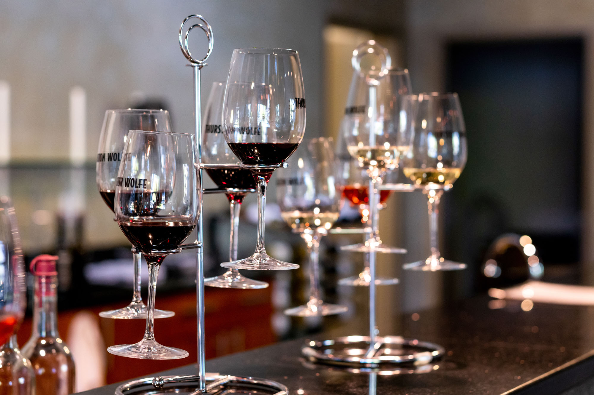 Assorted wine glasses on a modern stand display.